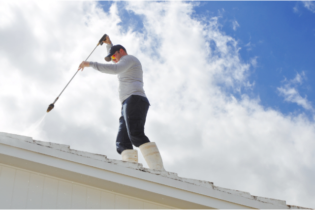 Costa Mesa Day laborer pressure cleaning a roof